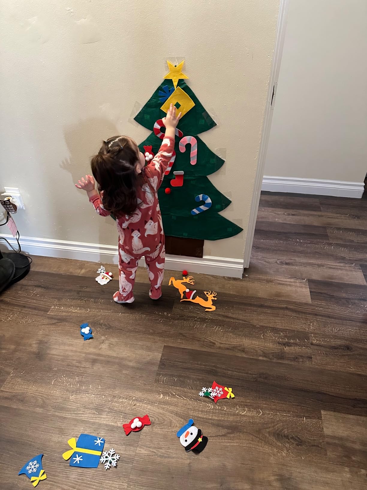 Toddler decorating a felt tree